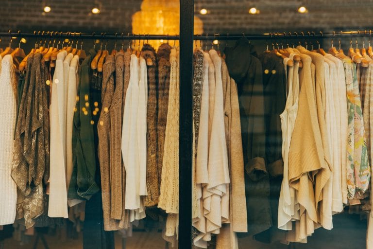 Victoria Jenkins is a fashion designer. Image depicts a range of clothing on a rail.