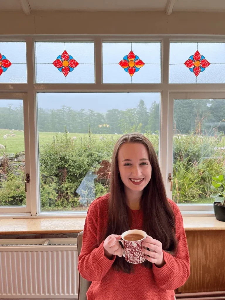 Girl smiling drinking a cup of tea