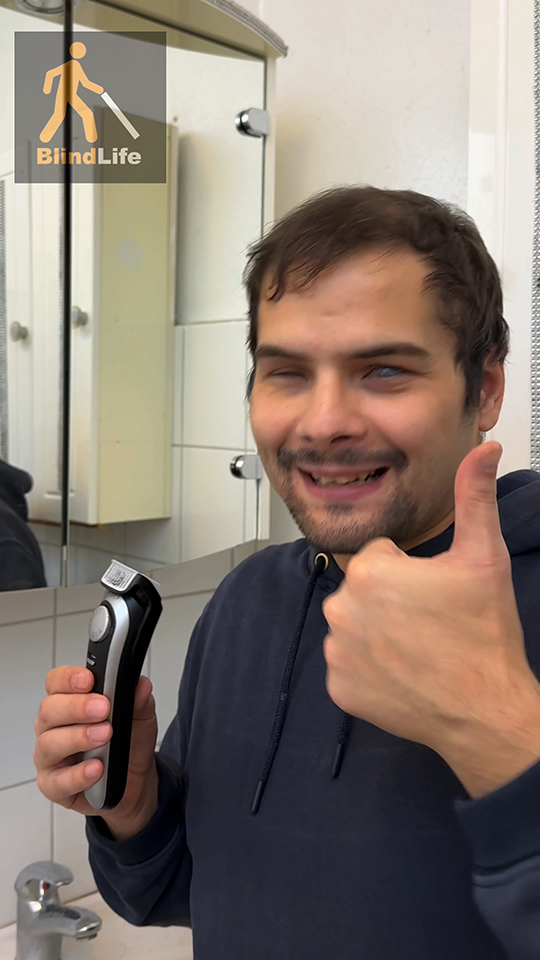 A visually impaired man is holding the new Braun shaver and giving a thumbs up to the camera.