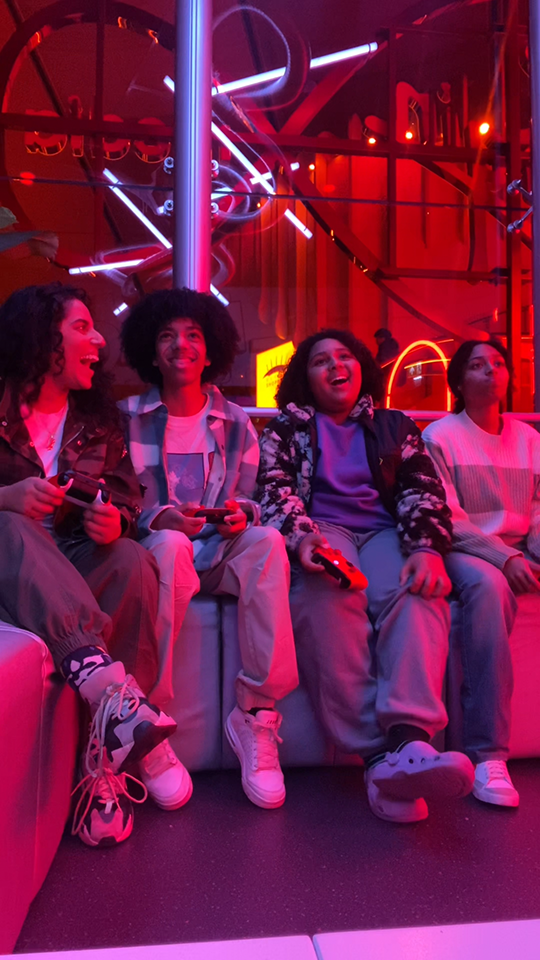 The children of the Blackistani family sit in Virgin Media's gamepad location - playing a computer game together.