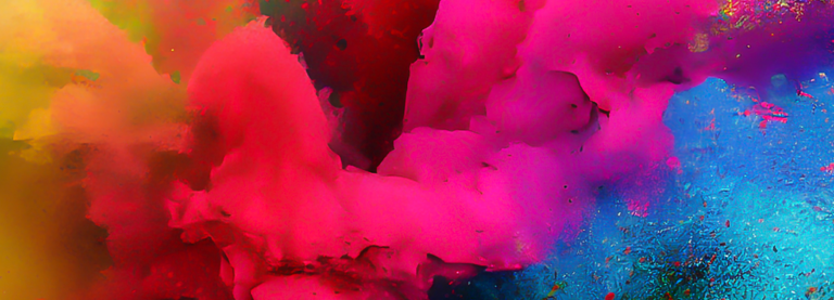A photograph close-up of bright, coloured powder being blown towards the viewer.