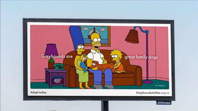 The Simpson family sit on the couch petting their greyhound called "Santa's Little Helper." Text around this scene says "Greyhounds are great family dogs."