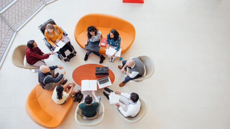 A photo taken from above of diversity training being carried out around a table