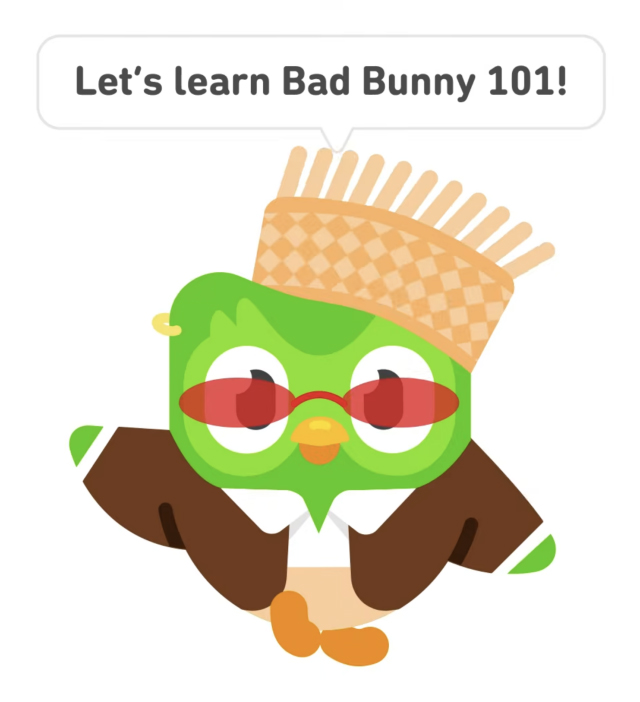 The Duolingo owl dressed up in a Bad Bunny inspired outfit including a pava hat. Text in a speech bubble above the owl reads: "Let's learn Bad Bunny 101!"