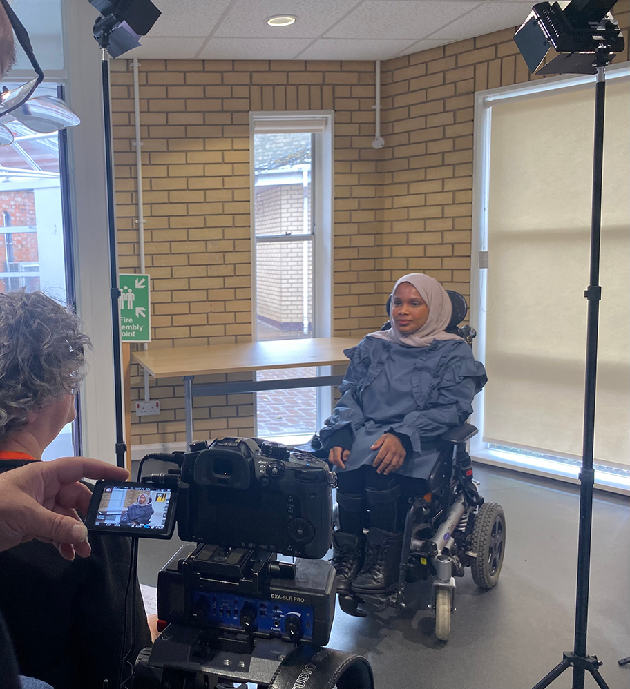 Umaymah is being filmed for an interview.