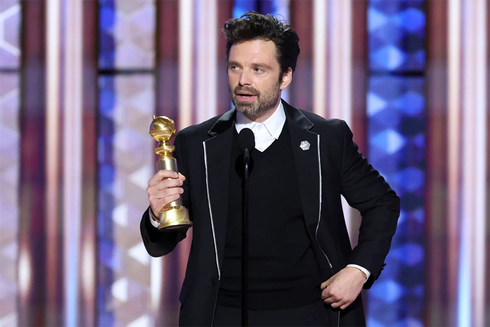 Sebastian Stan receiving his Golden Globe for his role of Edward in 'A Different Man.'