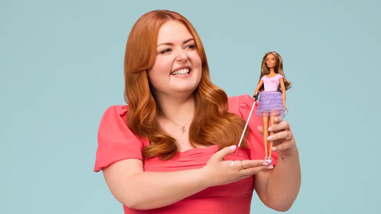 Inclusive marketing example - Lucy Edwards smiles as she holds up the new 'Blind Barbie' toy.
