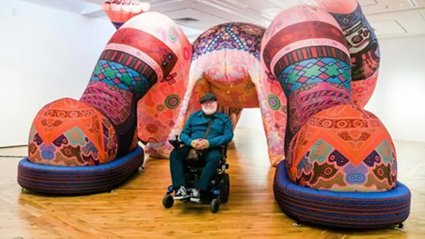 Jason Wilsher-Mills proudly presents one of his large sculptures in an art installation space.