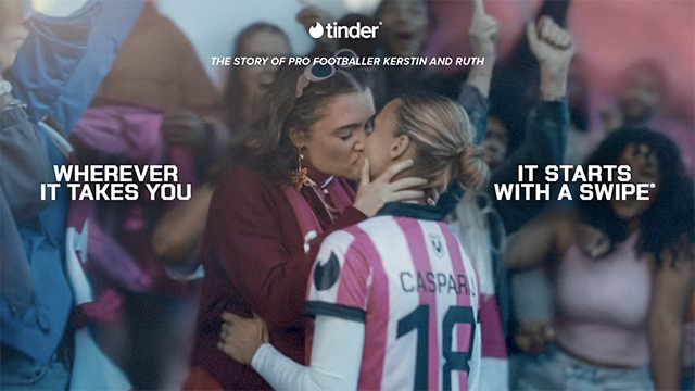 Kerstin and Ruth embrace as they celebrate Kerstin's success on the pitch. Text around them from Tinder has their names, and says: "Wherever it takes you, it starts with a swipe."
