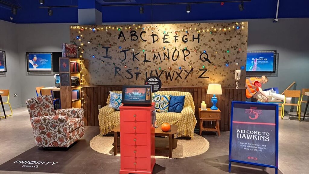 Immersive experience of Stranger Things showing Joyce's living room with A-Z letters written on the wall.
