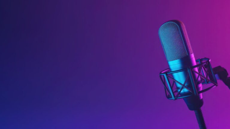 A podcast mic positioned in front of a purple gradient background.