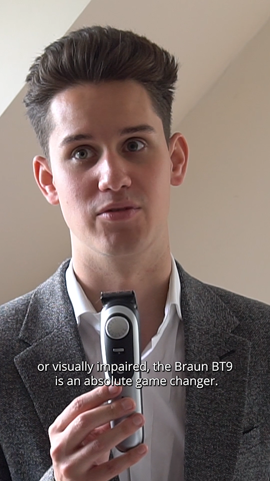 Toby, a white man with short brown hair, is holding a Braun shaver while talking to the camera.