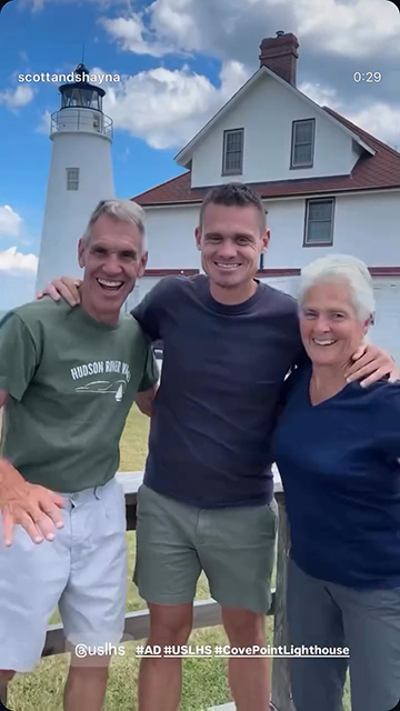 For U.S. Lighthouse Society Campaign, Man poses for a photo outside of a lighthouse with two senior relatives.
