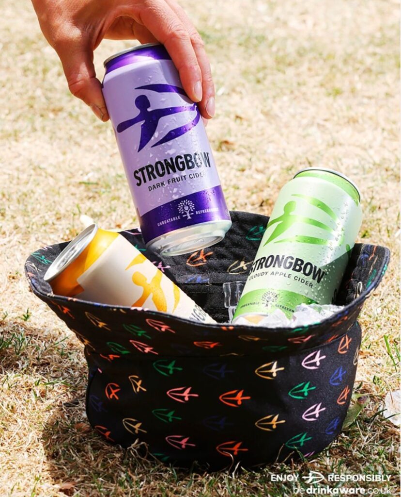 Picture from Strongbow's Instagram showing three cider cans inside a bucket hat with Strongbow's logo all over it.