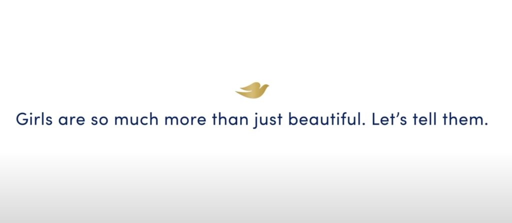A white background with the 'Dove' logo and some text that says 'Girls are so much more than just beautiful. Let's tell them'.