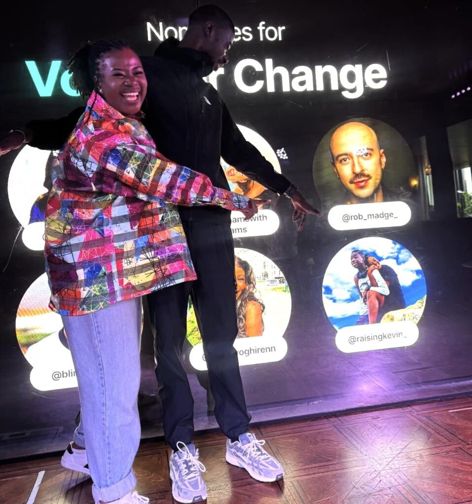 A black woman and her son are pointing at their TikTok nomination for 'voice for change'. Their handle is @raisingkevin_