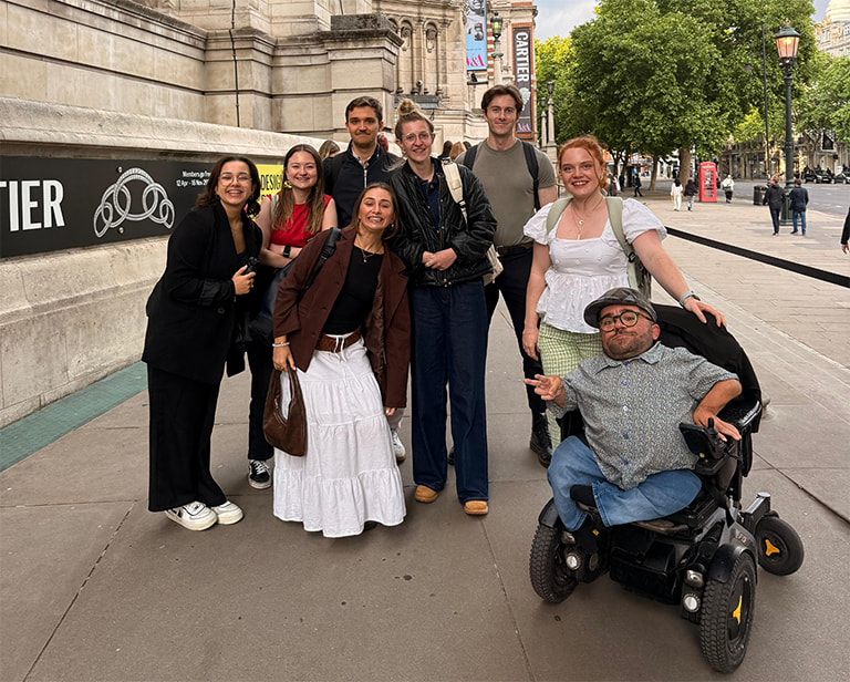 The Purple Goat Team poses for a photograph outside of the V&A South Kensington Museum on the opening night of the Design and Disability exhibition.