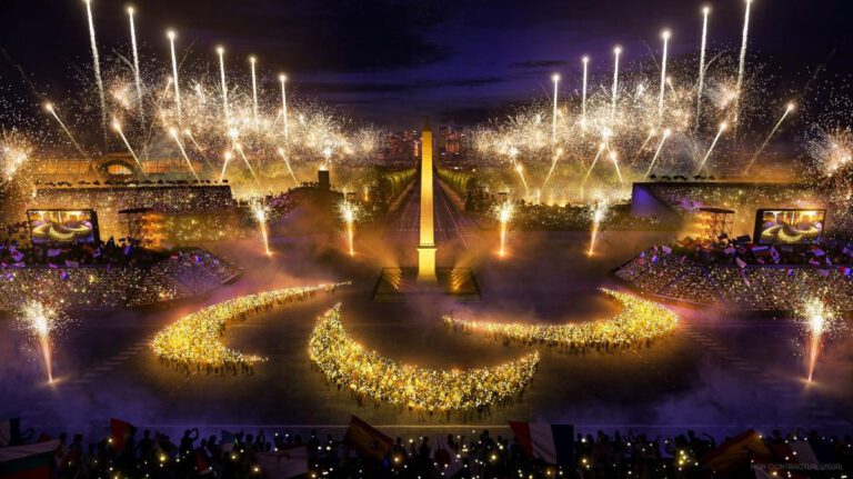 Fireworks at the Opening Ceremony of the 2024 Paralympic Games in Paris. People are holding up torches in a pattern that resembles the Paralympics logo.