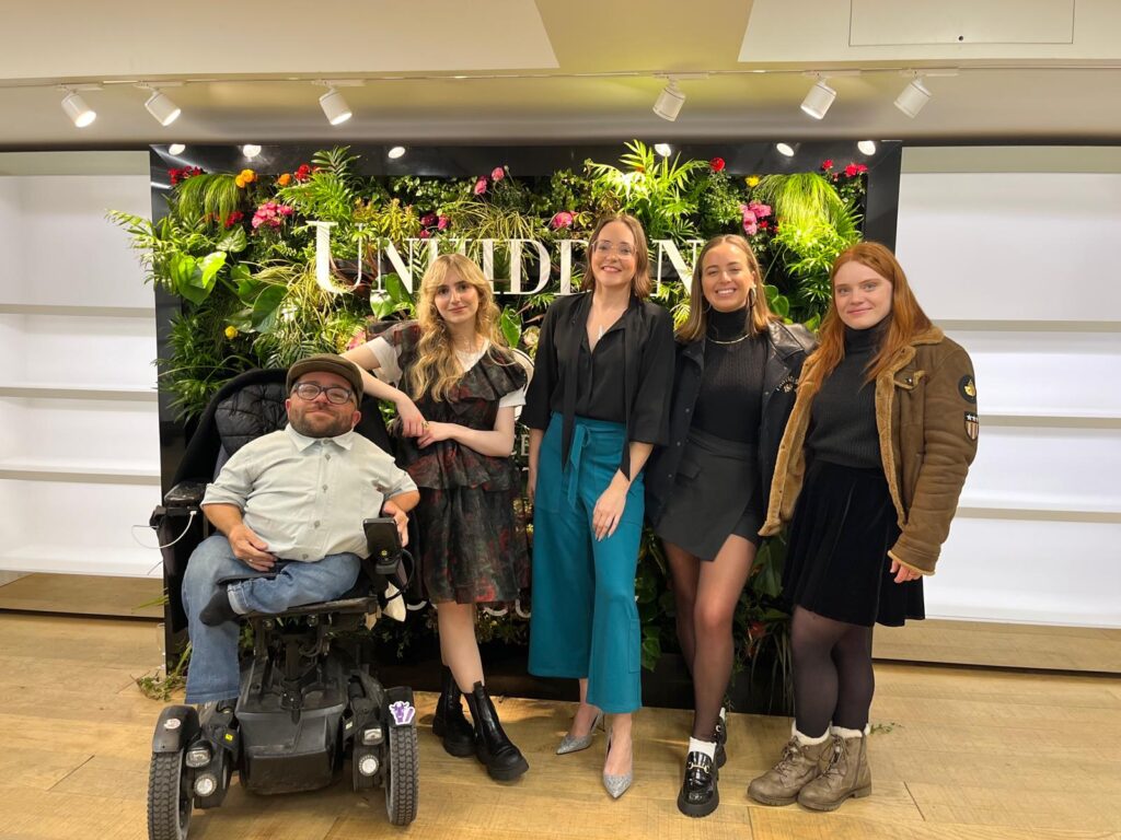 Victoria Jenkins poses with some members of the Purple Goat Agency team at the show for her brand 'Unhidden Clothing'.