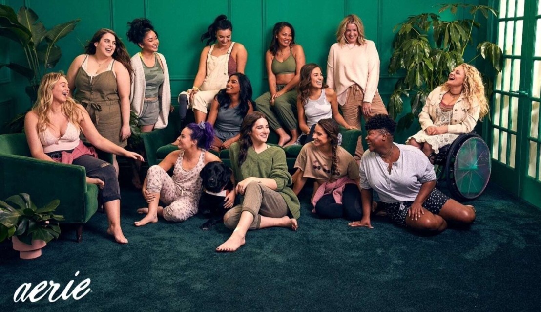 A diverse group of women are laughing together for an Aerie campaign.