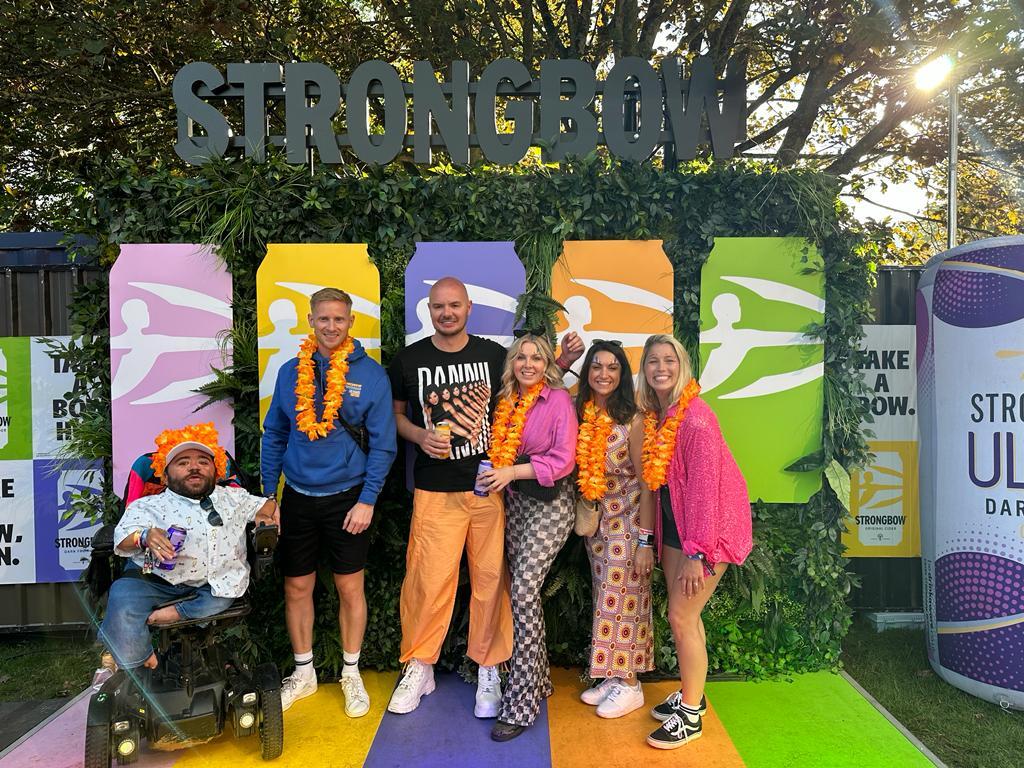Some of the Purple Goat team and Strongbow team posing and smiling together at the Strongbow yard during Brighton Pride.