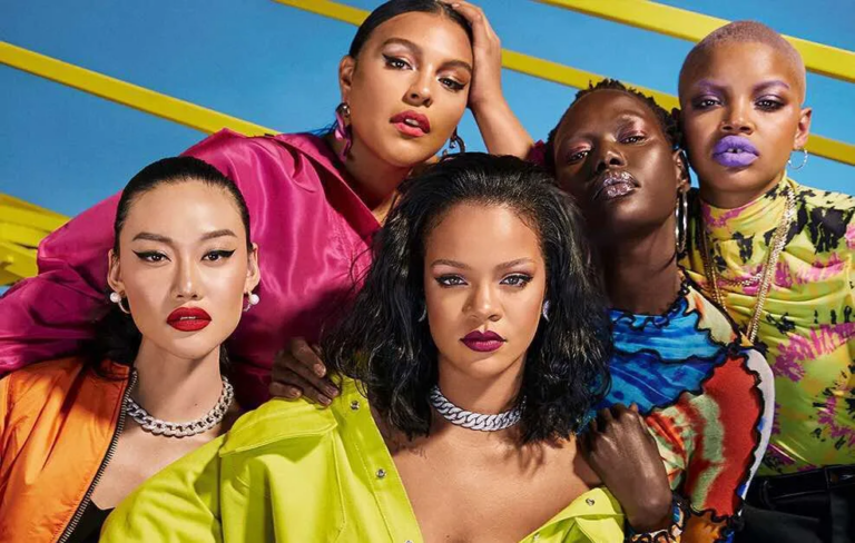 Rihanna posing in a group shot with a diverse group of models.
