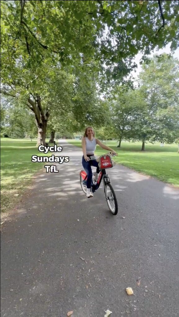 Still of Jazzy Whips' content for TfL's Cycle Sundays Campaign. Jazzy is on a bicycle, text on screen says, "Cycle Sundays TfL". 