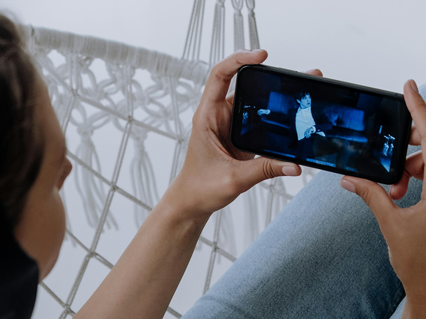 A person holding a phone while watching a YouTube video.