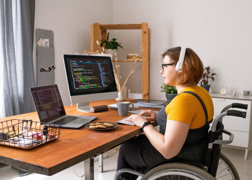 Woman In Wheelchair Working From Home As A Developer Or Software Engineer
